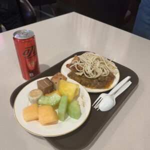 Tray with noodles, fruit and a drink in the Shanghai airport lounge